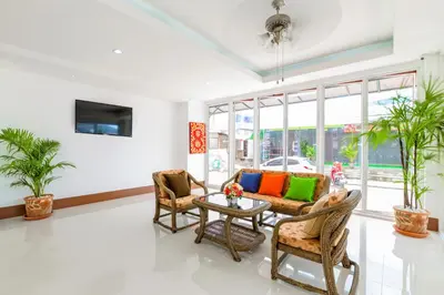 a living room with chairs and a table at Phusita Hotel - SHA Certified in Patong Beach