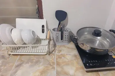 a kitchen counter with utensils and a strainer at House No.2 Village in Krabi town