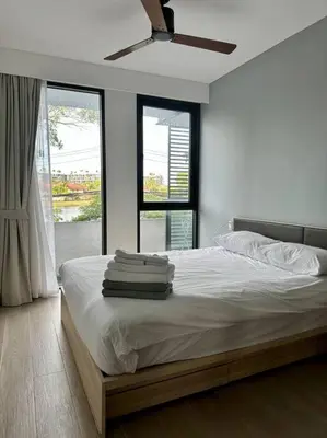 a bedroom with a bed with towels on it at Cassia Residences in Phuket Town