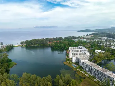 an aerial view of a building on a lake at Cassia 2 BR Sea View apt by NLA in Phuket Town
