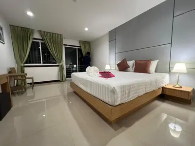 a bedroom with a large bed in a room at Zephyr Grand Hotel in Patong Beach