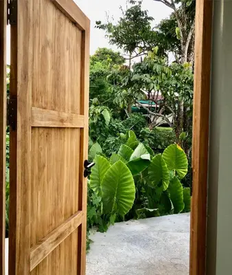 an open door with a garden in the background at Cozy Private Pool Villa For Family - Halal in Ban Thalat Choeng Thale