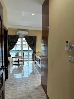 a hallway with a door open to a living room at BT hotel Kata Beach in Kata Beach