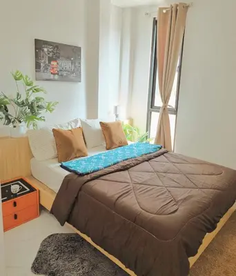 a bedroom with a bed and a window at Airhub Hostel Phuket Airport in Nai Yang Beach