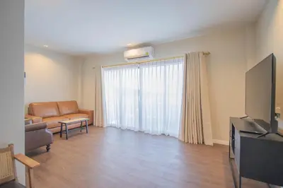 a living room with a couch and a television at The Va Phuket Patong in Patong Beach