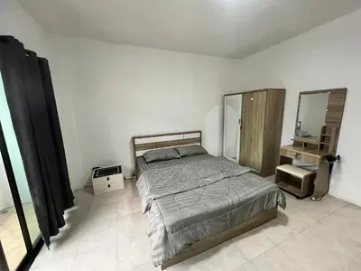 a bedroom with a large bed and a mirror at 84 Bar & Guest House in Ban Huai Luk (1)