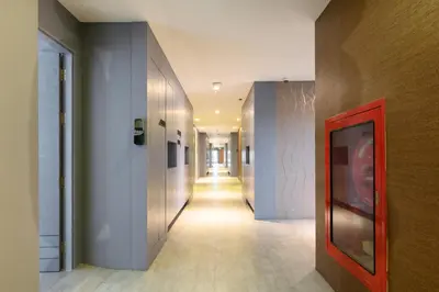 a hallway with a long hallway with white walls at City Gate Kamala B607 by Phuket Sabay Rent in Kamala Beach