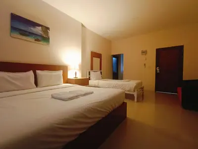 a hotel room with two beds and a lamp at Sj House Hotel Aonang in Ban Khlong Haeng