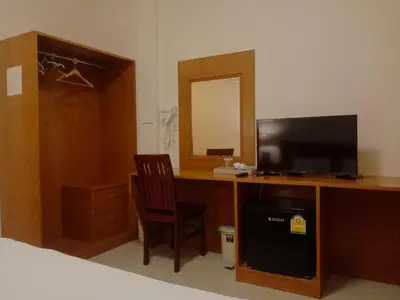 a bedroom with a desk with a television and a chair at Sj House Hotel Aonang in Ban Khlong Haeng