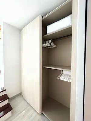 a walk in closet with a door open at A spacious Balinese style villa with a large swimming pool on Rawai an electric motorcycle as a gift! in Ban Saiyuan (1)