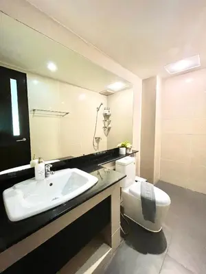 a bathroom with a sink and a toilet at The Kris 2 Bedrooms 2 Bathrooms Apartment in Patong Beach