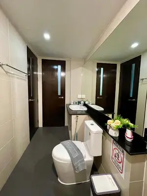a bathroom with a toilet and a sink at The Kris 2 Bedrooms 2 Bathrooms Apartment in Patong Beach