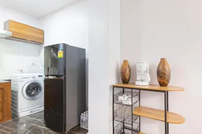 a kitchen with a refrigerator and a washer and dryer at Reach Patong beach in one minute in Patong Beach