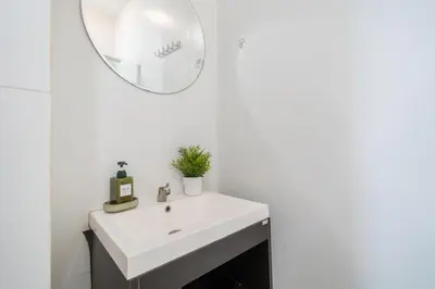a bathroom with a white sink and a mirror at Reach Patong beach in one minute in Patong Beach