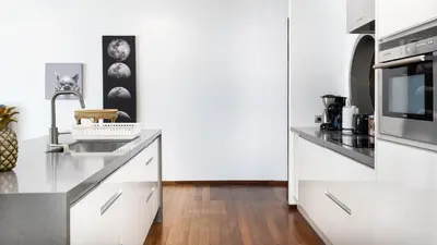 a white kitchen with a sink and a microwave at The Natai Villas - By AP Natai in Phang-nga