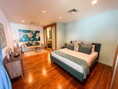 a bedroom with a bed and a living room at The Natai Villas - By AP Natai in Phang-nga