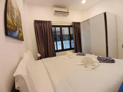 a bedroom with a large white bed with towels on it at Bayok 11 - 2 Bedrooms 2 Bathrooms Villa Near Kathu Waterfall in Ban Huai Luk (1)