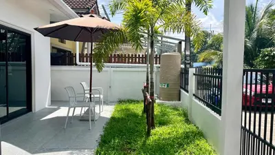 a patio with an umbrella and a table and chairs at Bayok 11 - 2 Bedrooms 2 Bathrooms Villa Near Kathu Waterfall in Ban Huai Luk (1)
