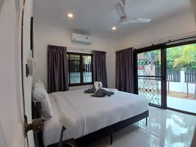 a bedroom with a bed and a large window at Bayok 11 - 2 Bedrooms 2 Bathrooms Villa Near Kathu Waterfall in Ban Huai Luk (1)