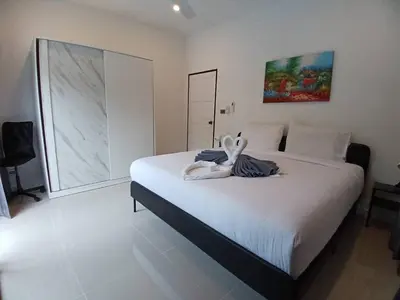 a bedroom with a bed with a stuffed animal on it at Bayok 11 - 2 Bedrooms 2 Bathrooms Villa Near Kathu Waterfall in Ban Huai Luk (1)