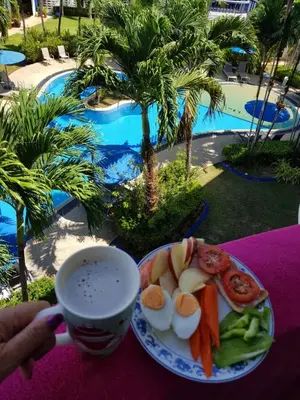 a plate of eggs and vegetables and a cup of coffee at Homely with pool near the beach in Kamala Phuket in Kamala Beach