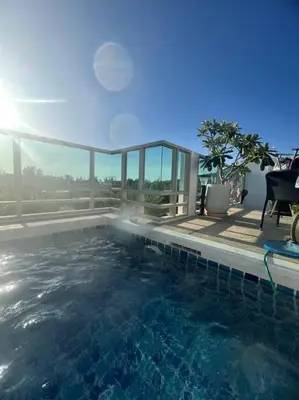 a swimming pool with a view of the ocean at The Regent Kamala Penthouse with private pool in Kamala Beach
