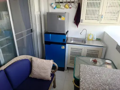 a small kitchen with a sink and a blue refrigerator at Phuket Palace apartment with 2 separate rooms in Patong Beach