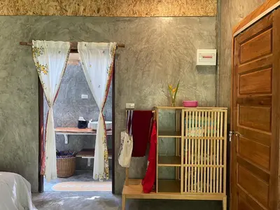 a room with a bed and a closet and a door at Big hug home-Forest House in Ban Takhrai