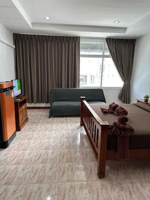 a hotel room with a bed and a couch at BT hotel Kata Beach in Kata Beach