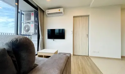 a living room with a couch and a tv at Laguna Skypark in Phuket Town