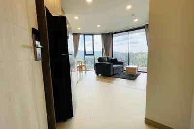 a living room with a black chair and a couch at Laguna Skypark in Phuket Town