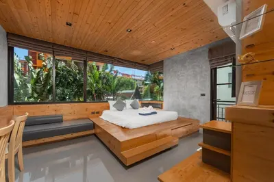 a bedroom with a bed and a large window at Modern studio at Relife 2 min to Nai Harn beach in Rawai Beach