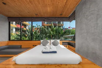 a bedroom with a large bed with two towels on it at Modern studio at Relife 2 min to Nai Harn beach in Rawai Beach