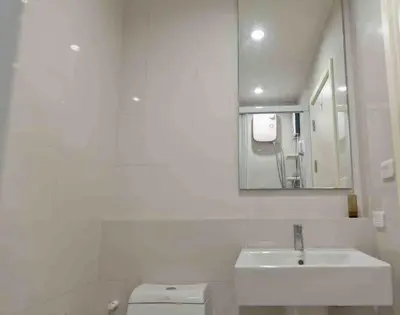 a white bathroom with a sink and a toilet at Luxury condo in phuket shopping center in Phuket Town