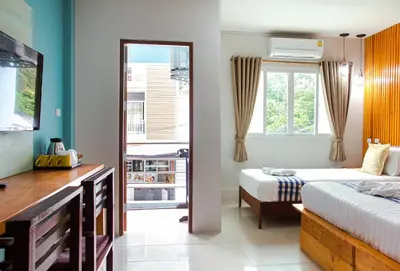a bedroom with two beds and a window at Kamala Beach Residence in Kamala Beach