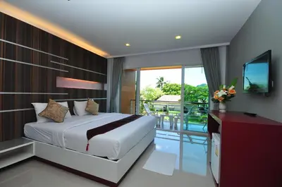 a bedroom with a large bed and a balcony at Phi Phi Rimlay Resort in Phi Phi Don