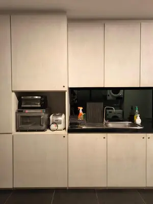 a kitchen with white cabinets and a microwave at Luxury Beachfront AMANA Villa 4 Br at Ta-Ke Residence A in Phuket Town