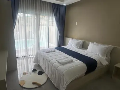 a bedroom with a large bed with a large window at Luxury Boutique Pool Villa Ao Nang Krabi in Ao Nam Mao
