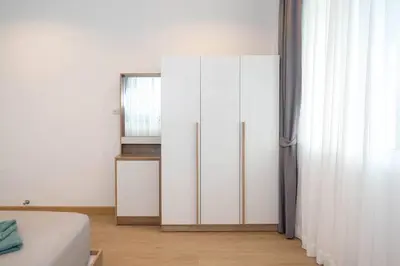 a bedroom with a white cabinet and a window at 2BR townhome 300M walk to kata beach Fully equipped in Kata Beach