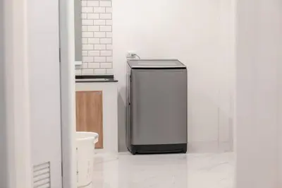 a bathroom with a toilet and a small refrigerator at 2BR townhome 300M walk to kata beach Fully equipped in Kata Beach