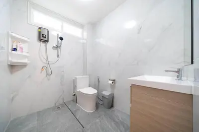 a white bathroom with a toilet and a sink at 2BR townhome 300M walk to kata beach Fully equipped in Kata Beach