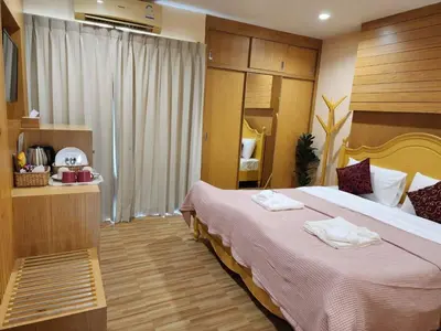 a hotel room with a bed with towels on it at Alaita Hostel Patong in Patong Beach