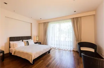 a bedroom with a bed and a large window at Pearl of Naithon 3 bedrooms in Nai Thon Beach