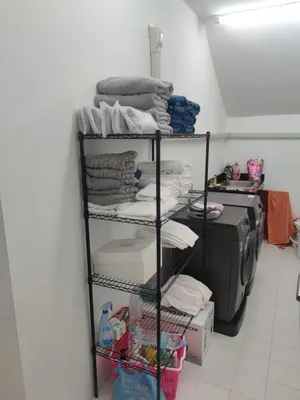 a room with a rack of clothes and a printer at The Residence Resort in Phuket Town