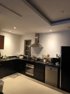 a kitchen with black counters and a stove top oven at The Residence Resort in Phuket Town