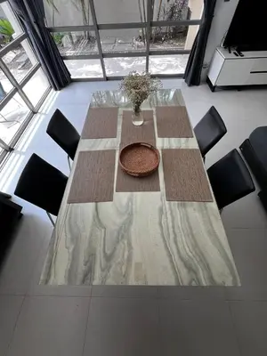 a table with chairs and a vase on top of it at The Residence Resort in Phuket Town