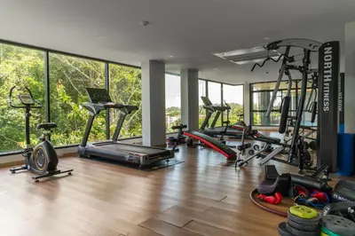 a gym with a bunch of exercise bikes in a room at Great Hill Tropic View Pool Gym Naiyang in Nai Yang Beach