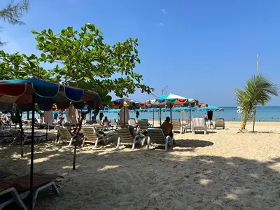 a group of chairs and umbrellas on a beach at Great Hill Tropic View Pool Gym Naiyang in Nai Yang Beach