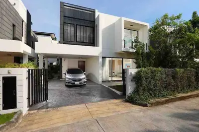 a car parked in the driveway of a house at Big Lucky home in Laguna park in Bang Tao Beach