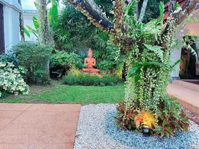 a statue in the middle of a garden at Saitaan Villa Dennapa Bang Tao Beach in Bang Tao Beach